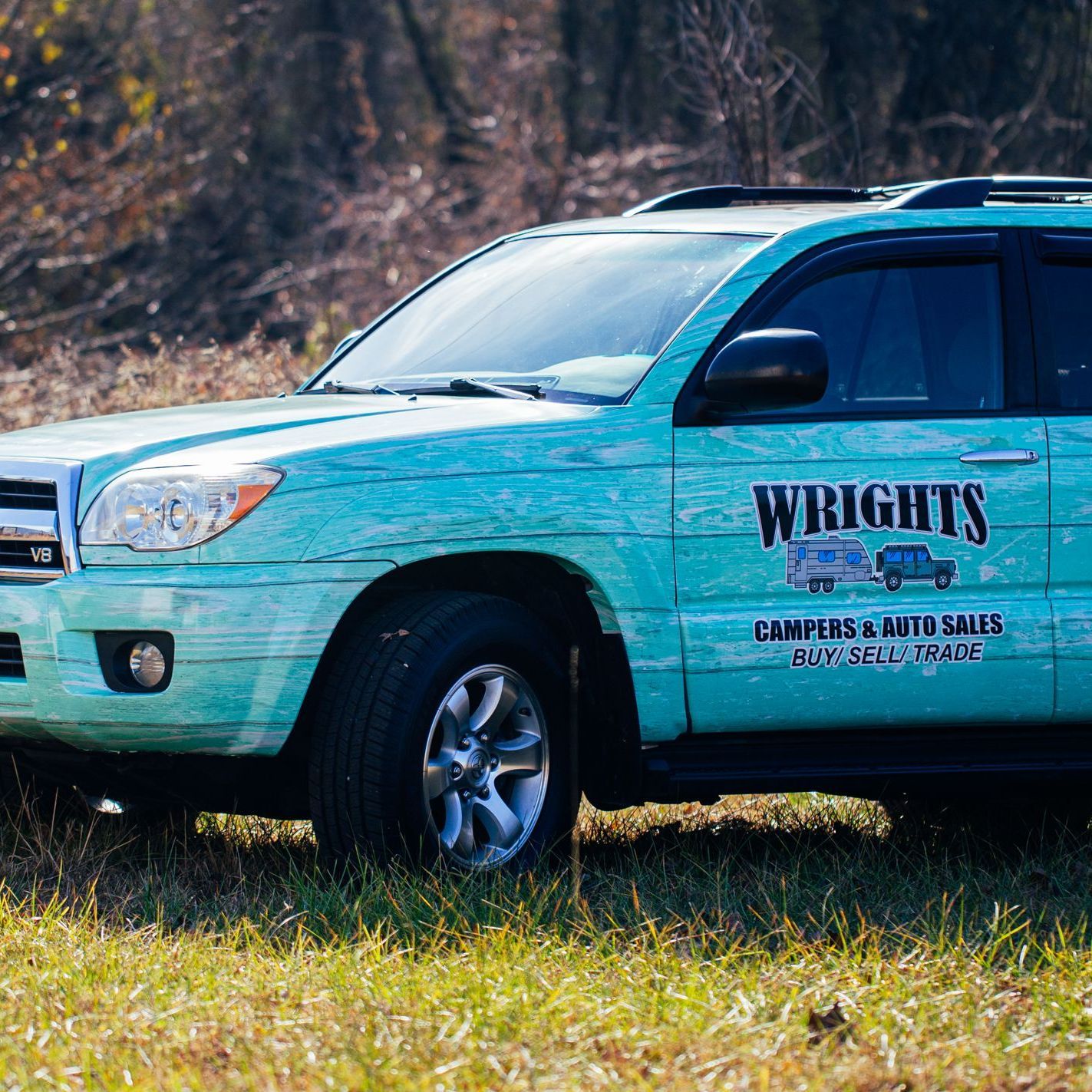 Vehicle wrap made to look like teal planks of wood for automotive company
