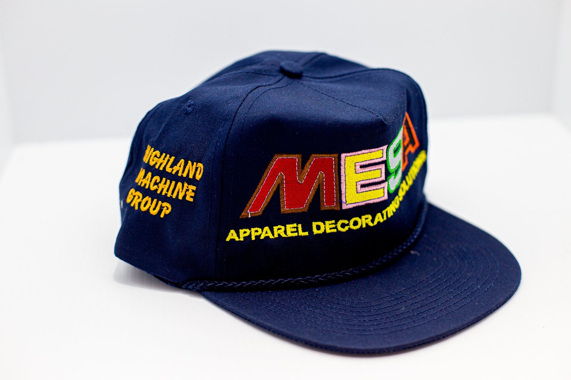 Navy blue embroidered hat with several colors like red, yellow, and green
