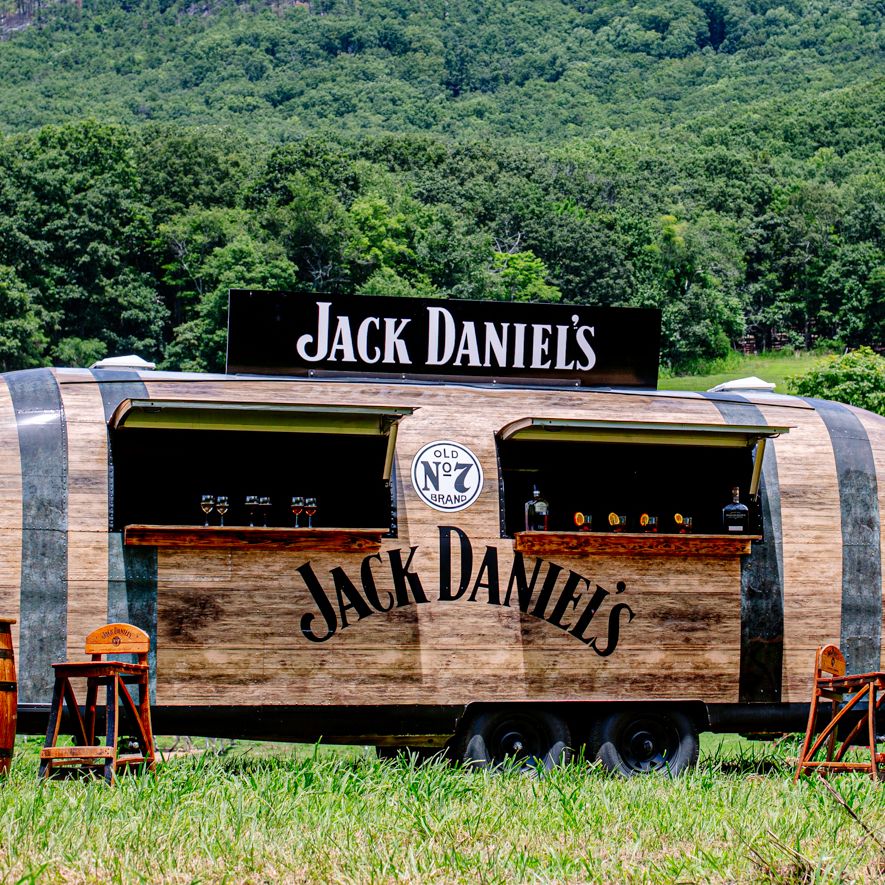 A renovated airstream renovated to look like a whiskey barrel and to be used as a brand activation