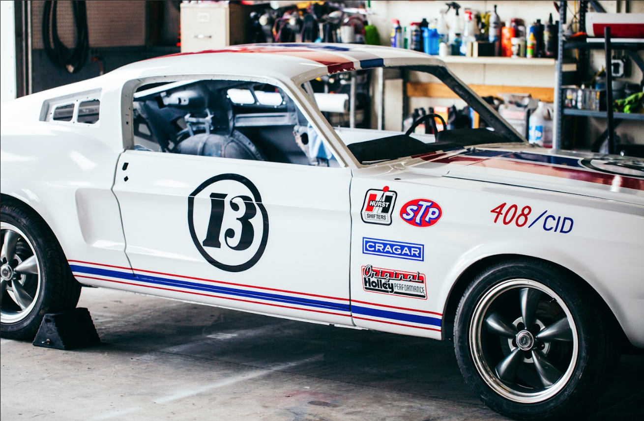 Personal vehicle wrap with red and blu stripe down the hood with number 13 next to the stripes