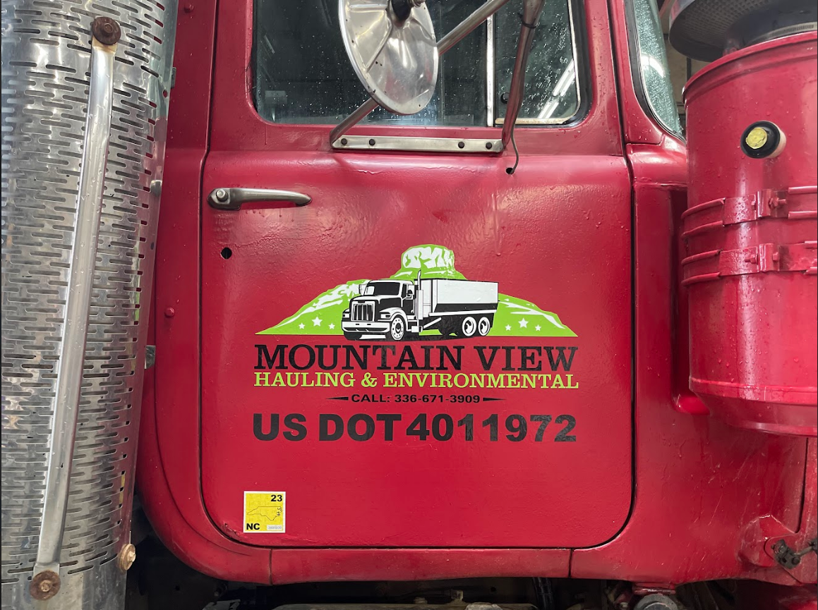 Spot decal on door of dump truck for waste management company