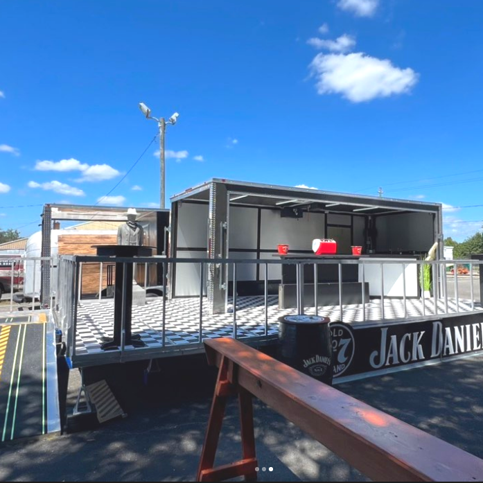 A mobile stage with ADA compliant ramp and functional bar to be used as a brand activation