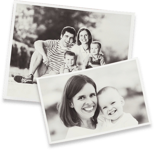 a black and white photo of a family and a woman holding a baby .