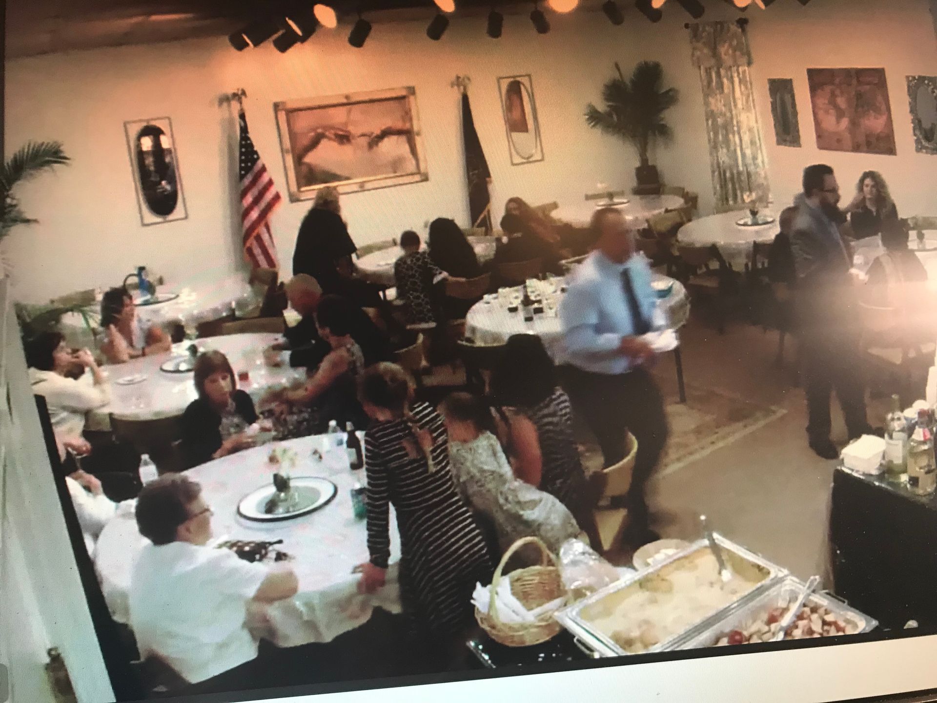 A group of people are sitting at tables in a room