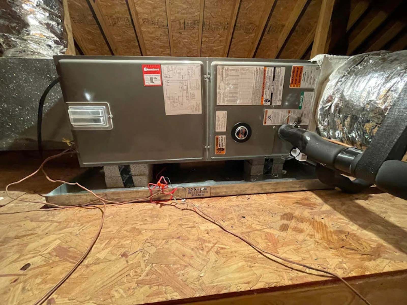 A ventilation system is installed in the attic of a house.