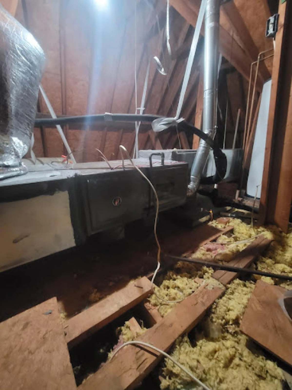 There is a lot of insulation in the attic of a house.