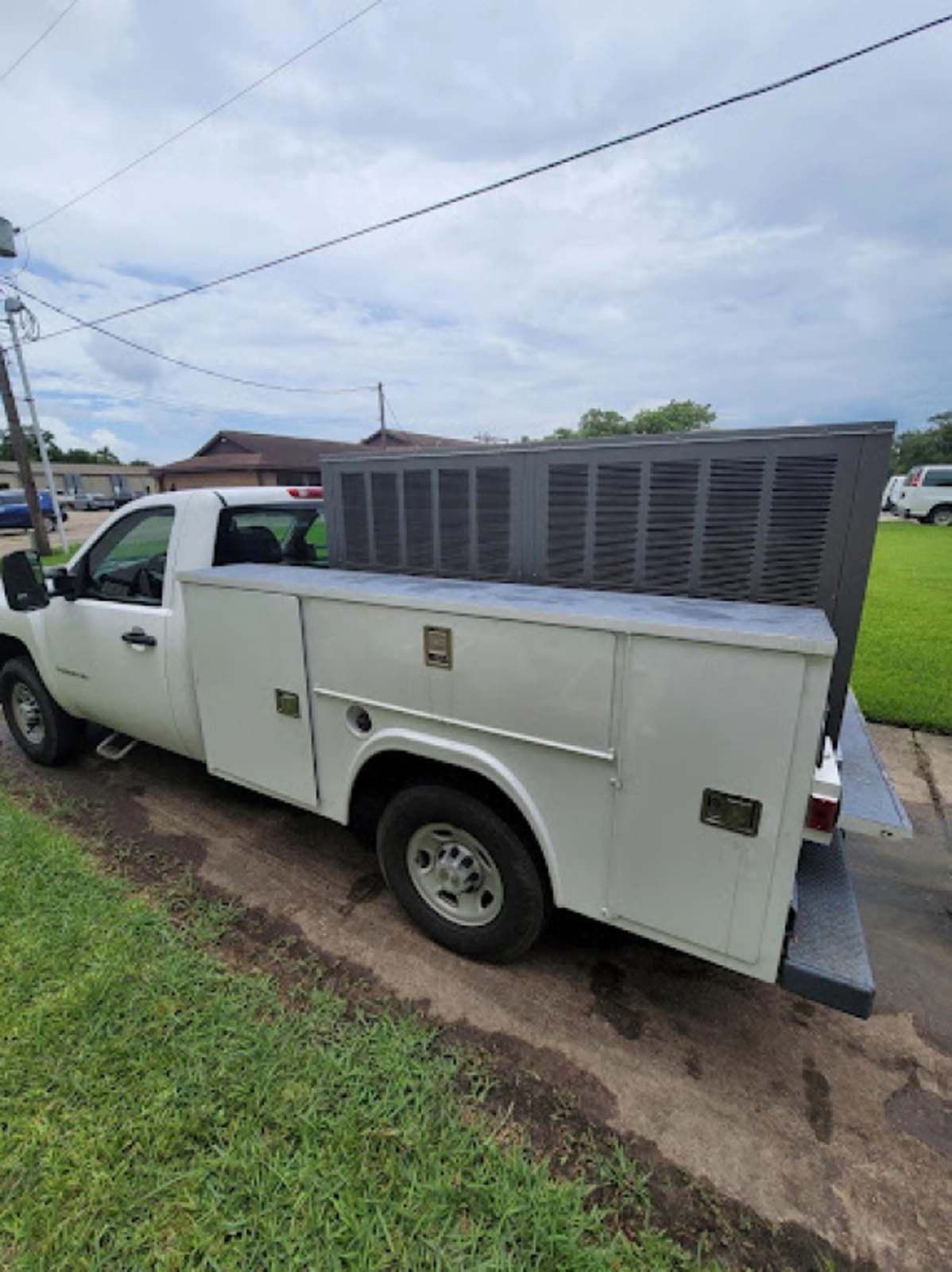A white utility truck is parked on the side of the road.
