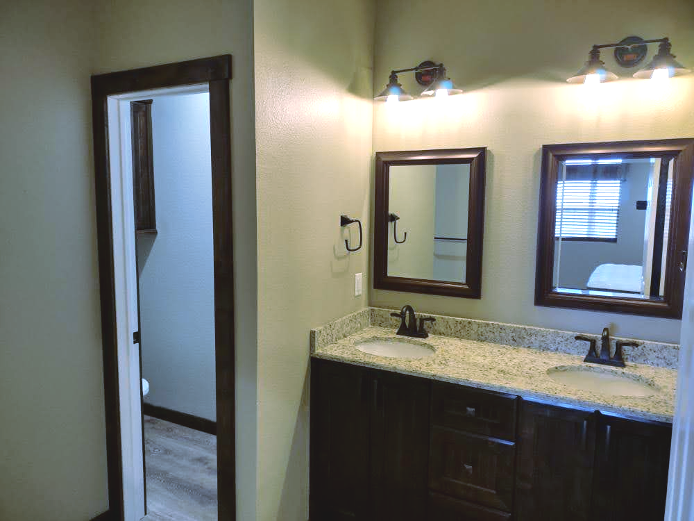 A bathroom with two sinks and two mirrors.