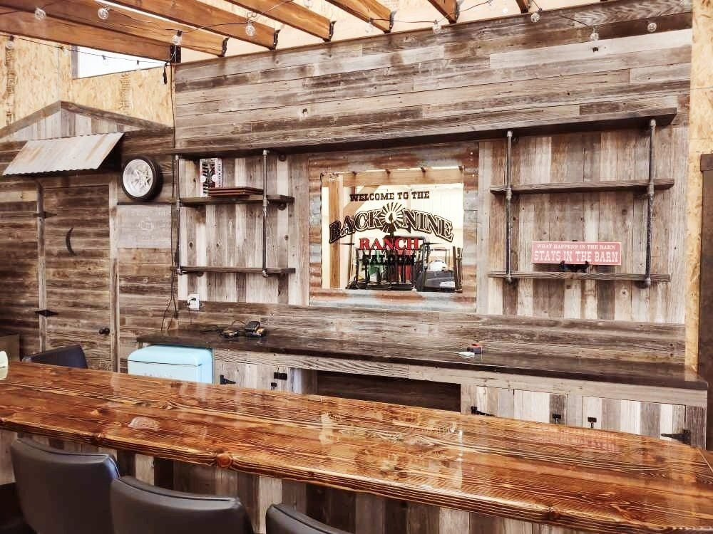 A wooden bar with a clock on the wall.