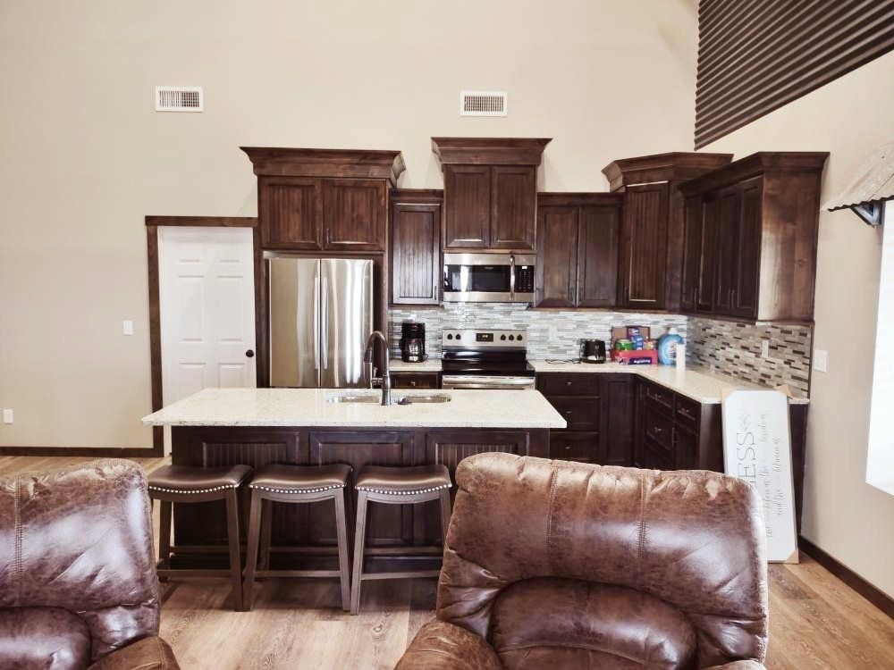 A kitchen with brown cabinets and stainless steel appliances