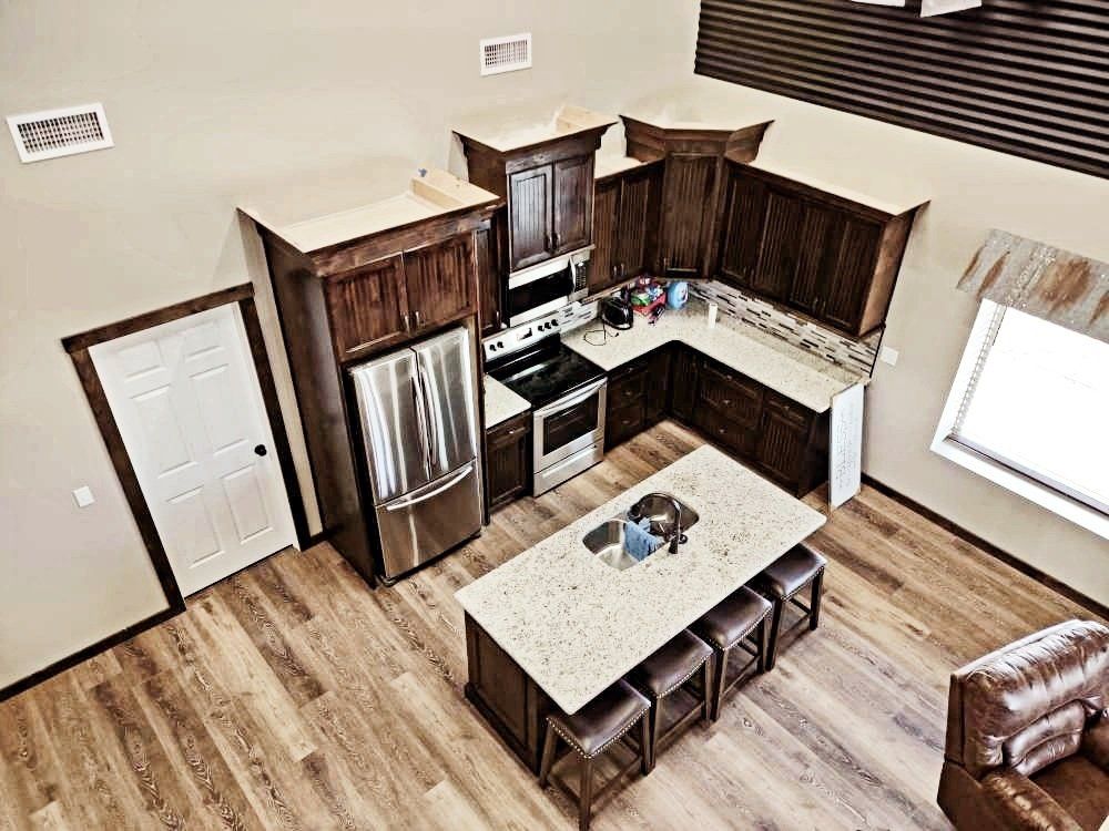 An aerial view of a kitchen with stainless steel appliances and a large island.