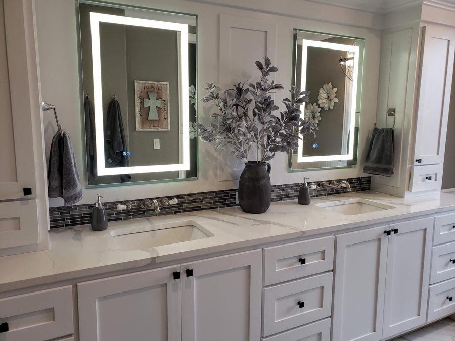 A bathroom with two sinks and two mirrors.