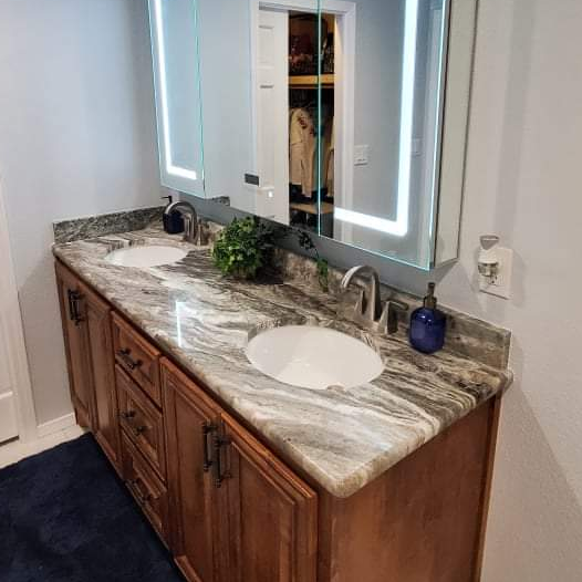 A bathroom with two sinks and a mirror.