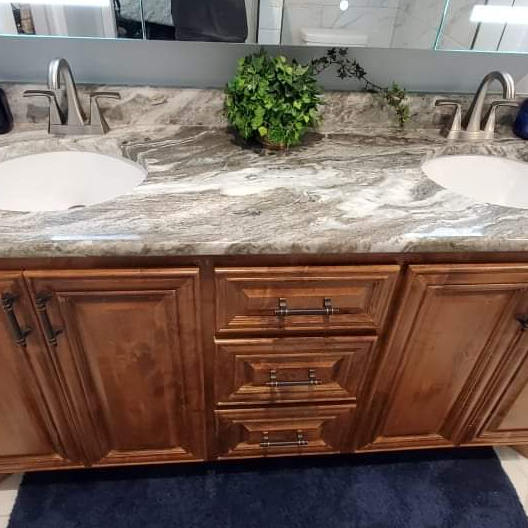 A bathroom vanity with two sinks and a mirror.