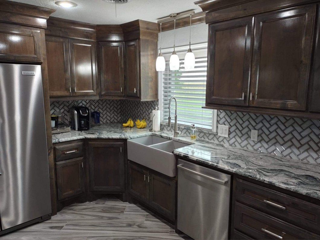 A kitchen with stainless steel appliances and wooden cabinets