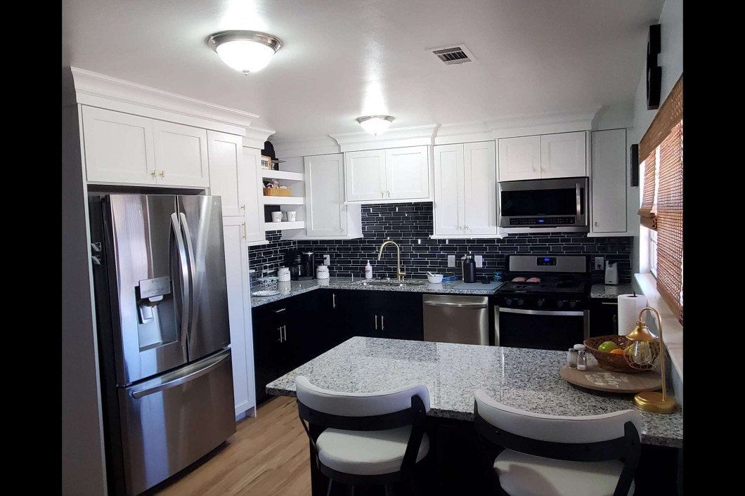 A kitchen with stainless steel appliances and granite counter tops