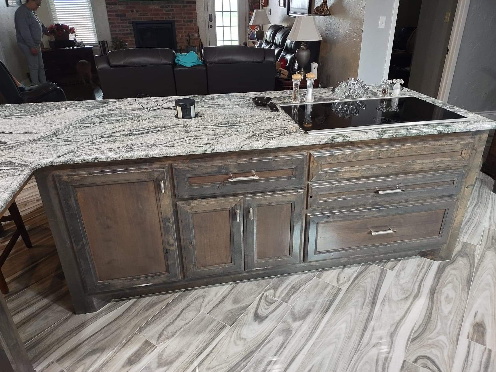 A kitchen with a large island and granite counter tops.