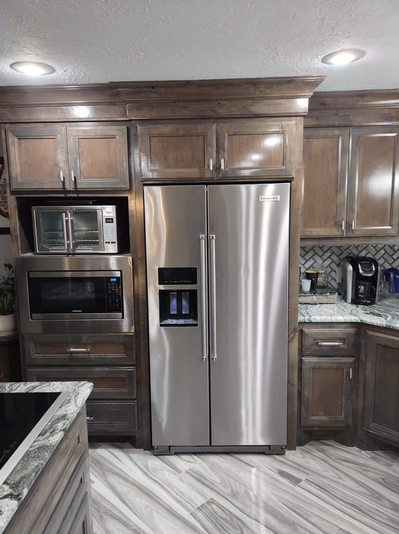 A kitchen with stainless steel appliances and wooden cabinets