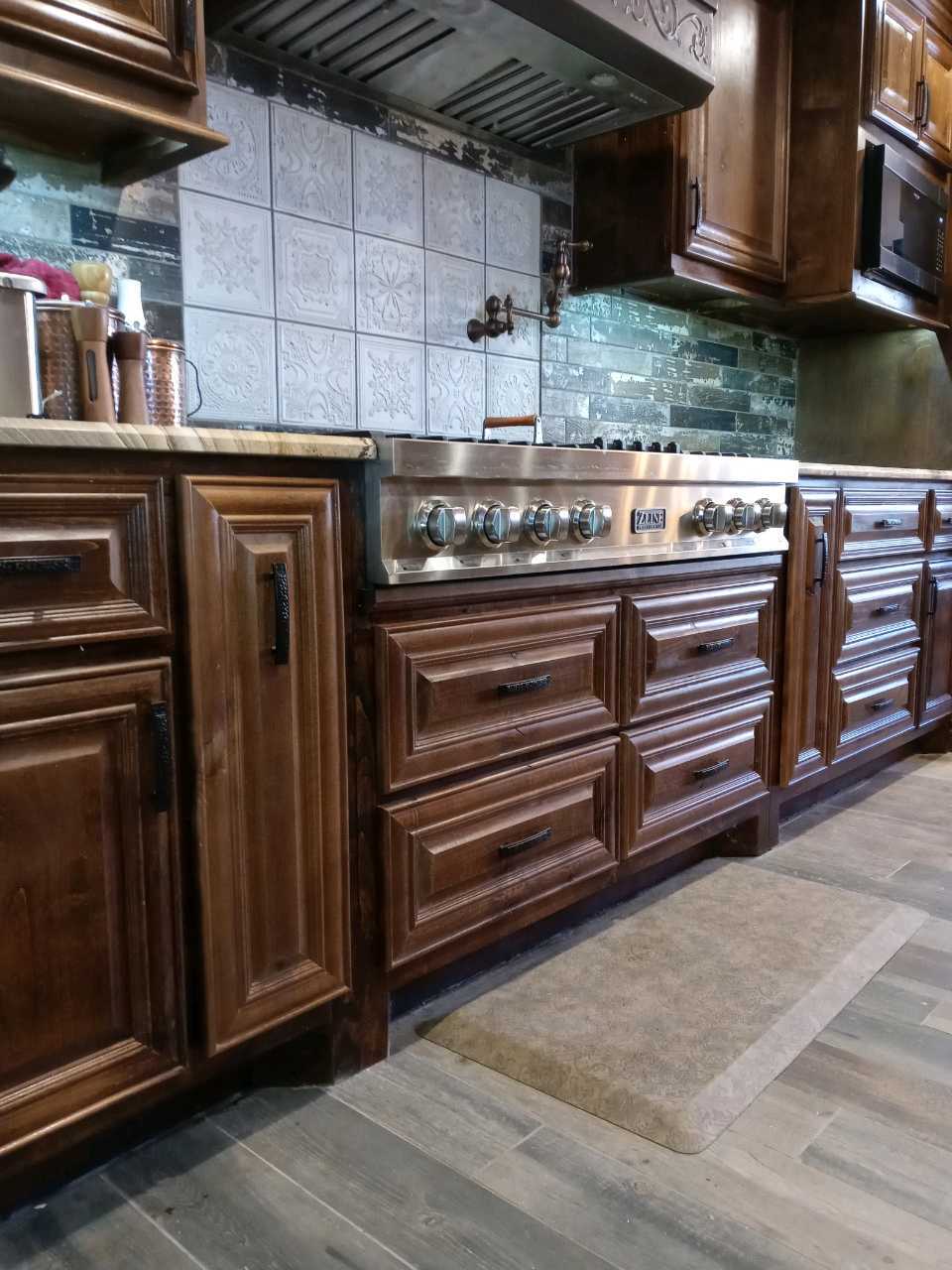 A kitchen with stainless steel appliances and wooden cabinets