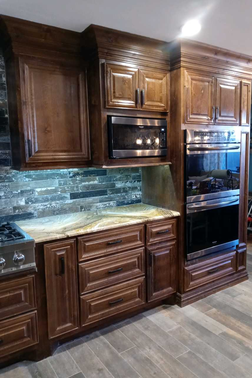 A kitchen with wooden cabinets and stainless steel appliances.