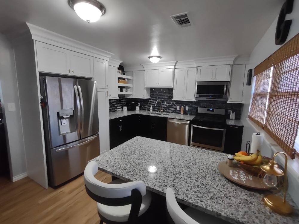 A kitchen with stainless steel appliances and granite counter tops