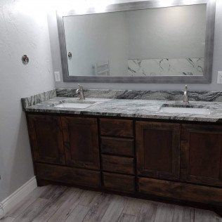 A bathroom with two sinks and a large mirror.