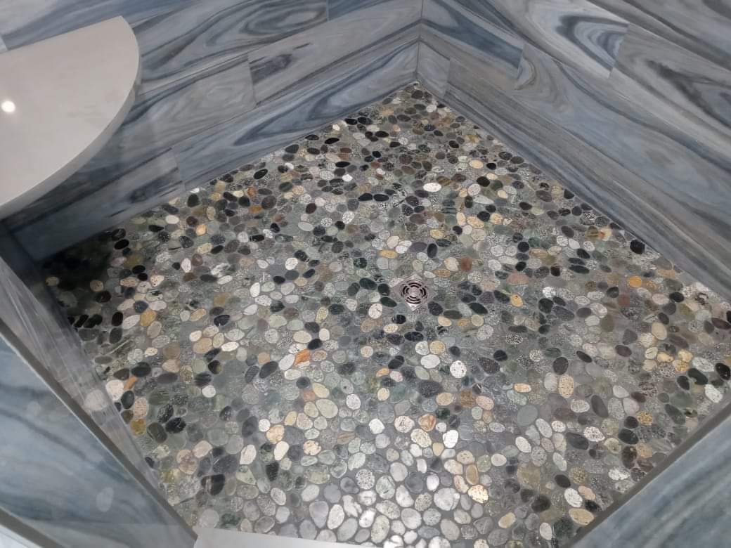 A bathroom floor with a lot of rocks on it