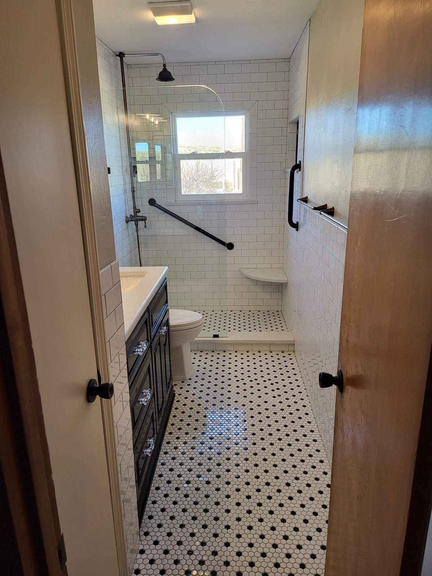 A bathroom with a toilet , sink , and shower.