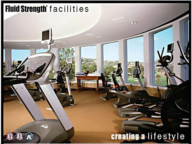 A picture of a gym with the words fluid strength facilities creating a lifestyle