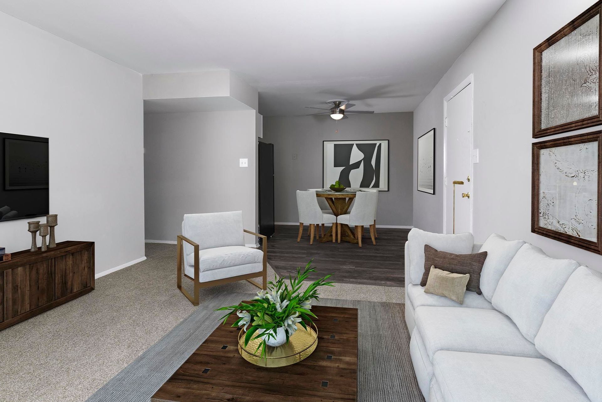 Living room with white sofa, armchair, and dining table, neutral colors, wood accents, and a potted plant.