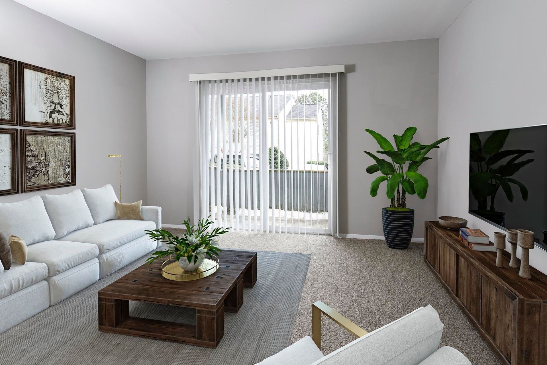 Living room with white sofa, wooden coffee table, and large potted plant.