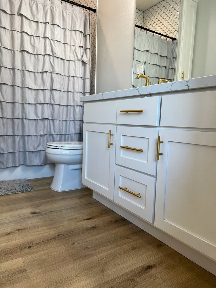 a bathroom with a toilet , sink , mirror and shower curtain .