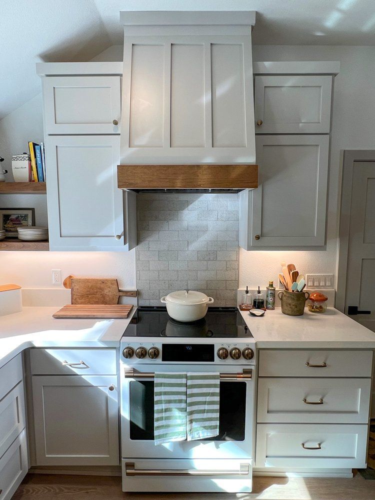 there is a pot on the stove in the kitchen .