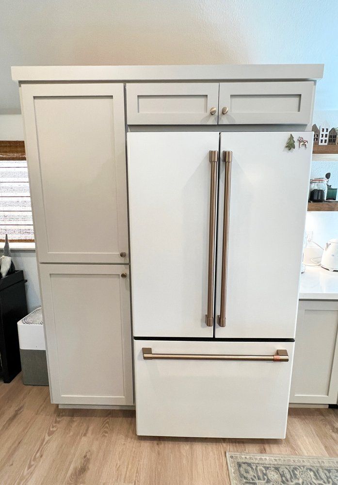 a white refrigerator freezer is sitting in a kitchen .
