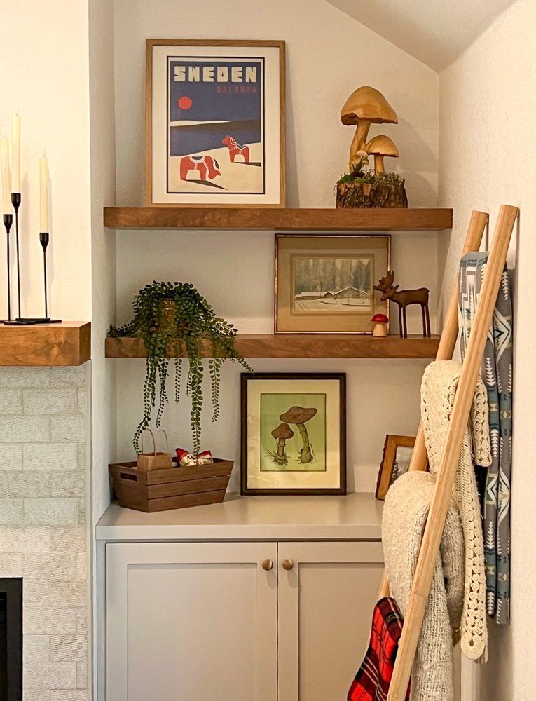 a living room with a fireplace and a shelf with a picture of sweden on it .