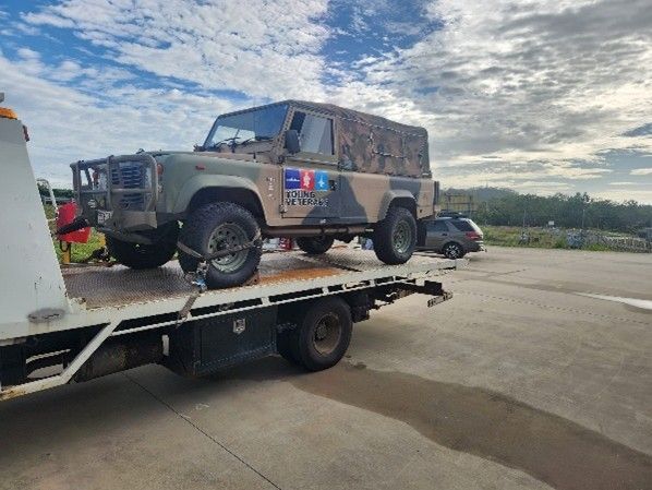 Red Car Being Towed by a White Tow Truck — Gladstone Fleet Maintenance In Gladstone, QLD