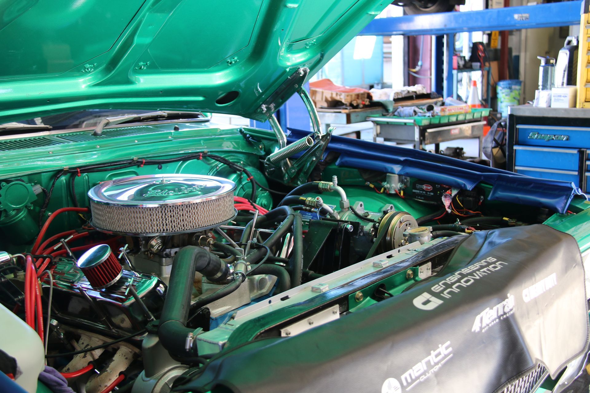 Green Car Engine Bay With Chrome Air Filter, in a Repair Shop — Gladstone Fleet Maintenance In Gladstone, QLD
