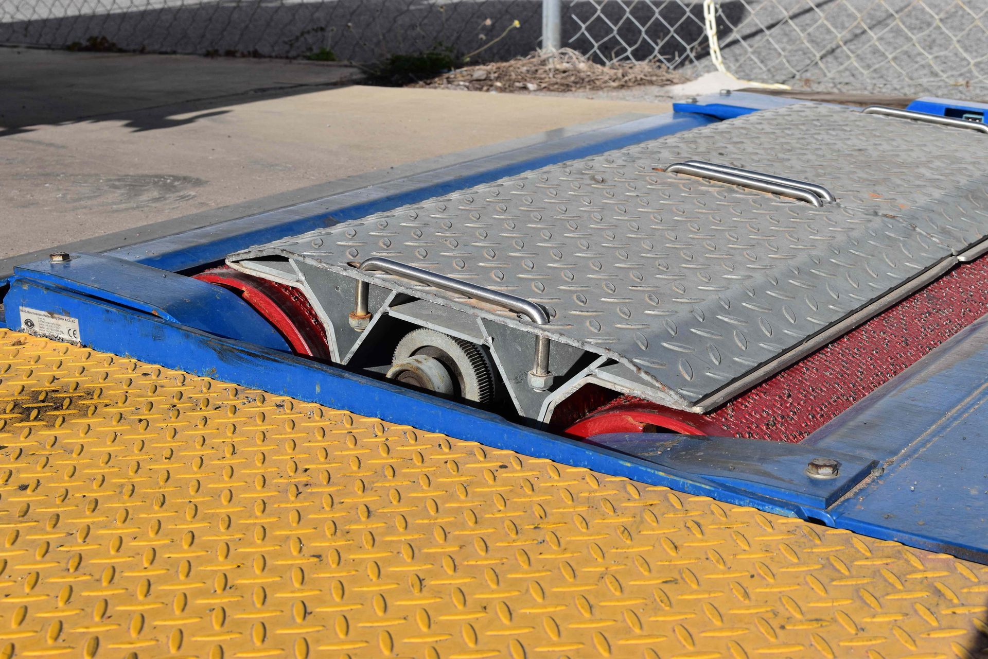 A Vehicle Inspection Machine With a Metal Platform and Red Rollers — Gladstone Fleet Maintenance In Gladstone, QLD
