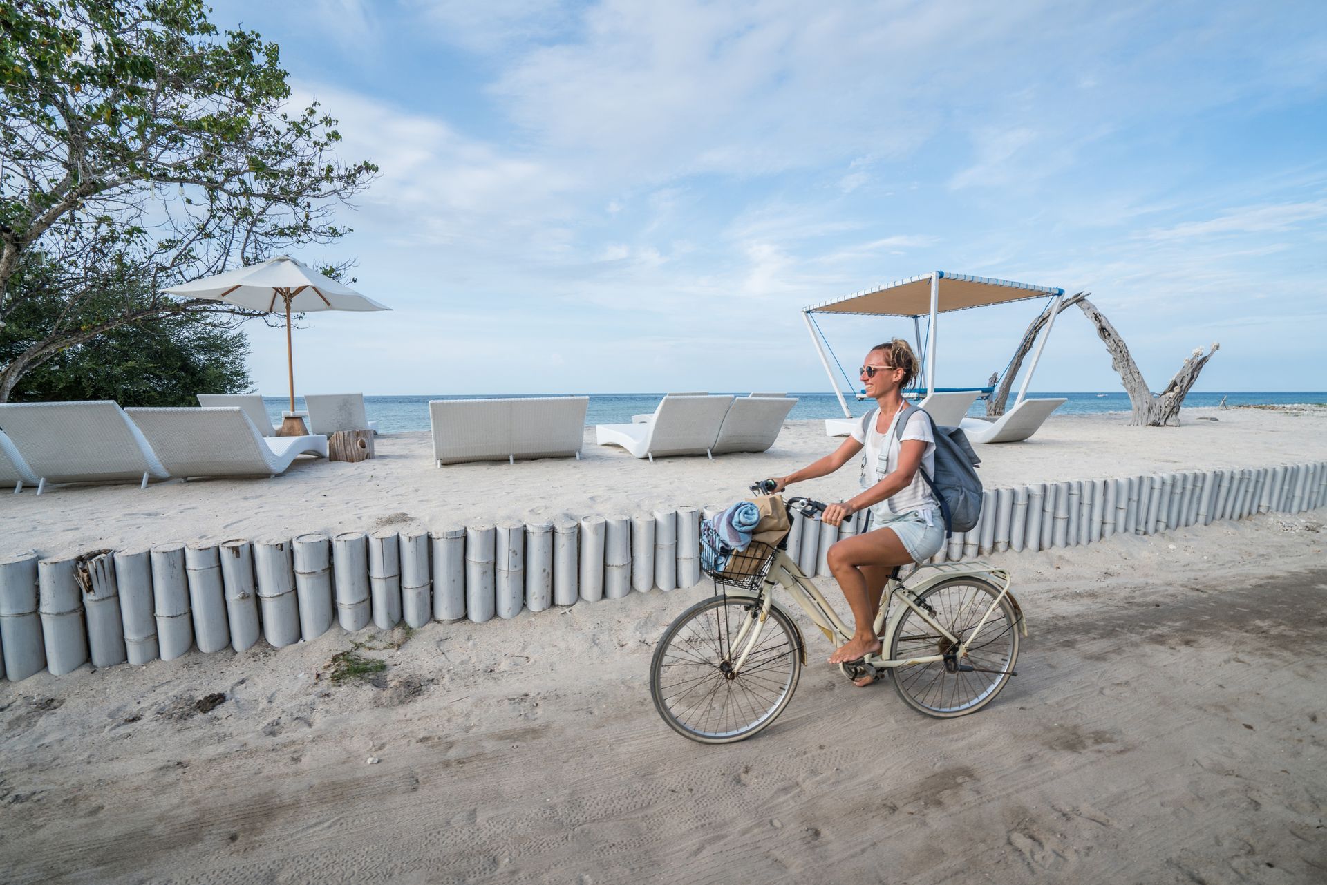 Young Woman Cycling By The Beach In The Morning — Miramar Beach, FL — Runaway Rentals LLC