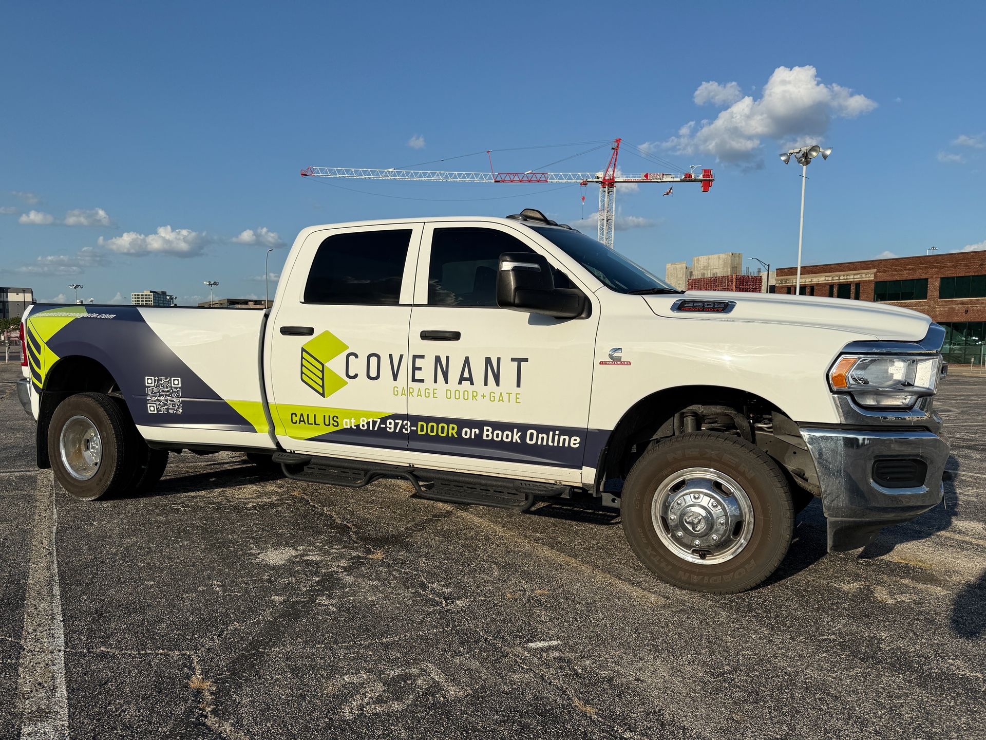 Covenant white pickup truck parked on gravel under a blue sky