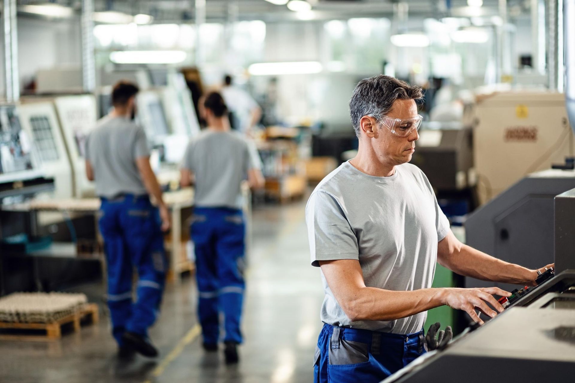 A man is working on a machine in a factory.