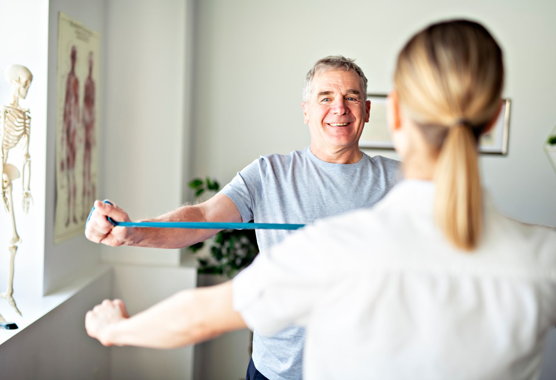 A woman is measuring a man 's arm with a tape measure.