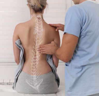 A man is examining a woman 's back with a drawing of a spine on it