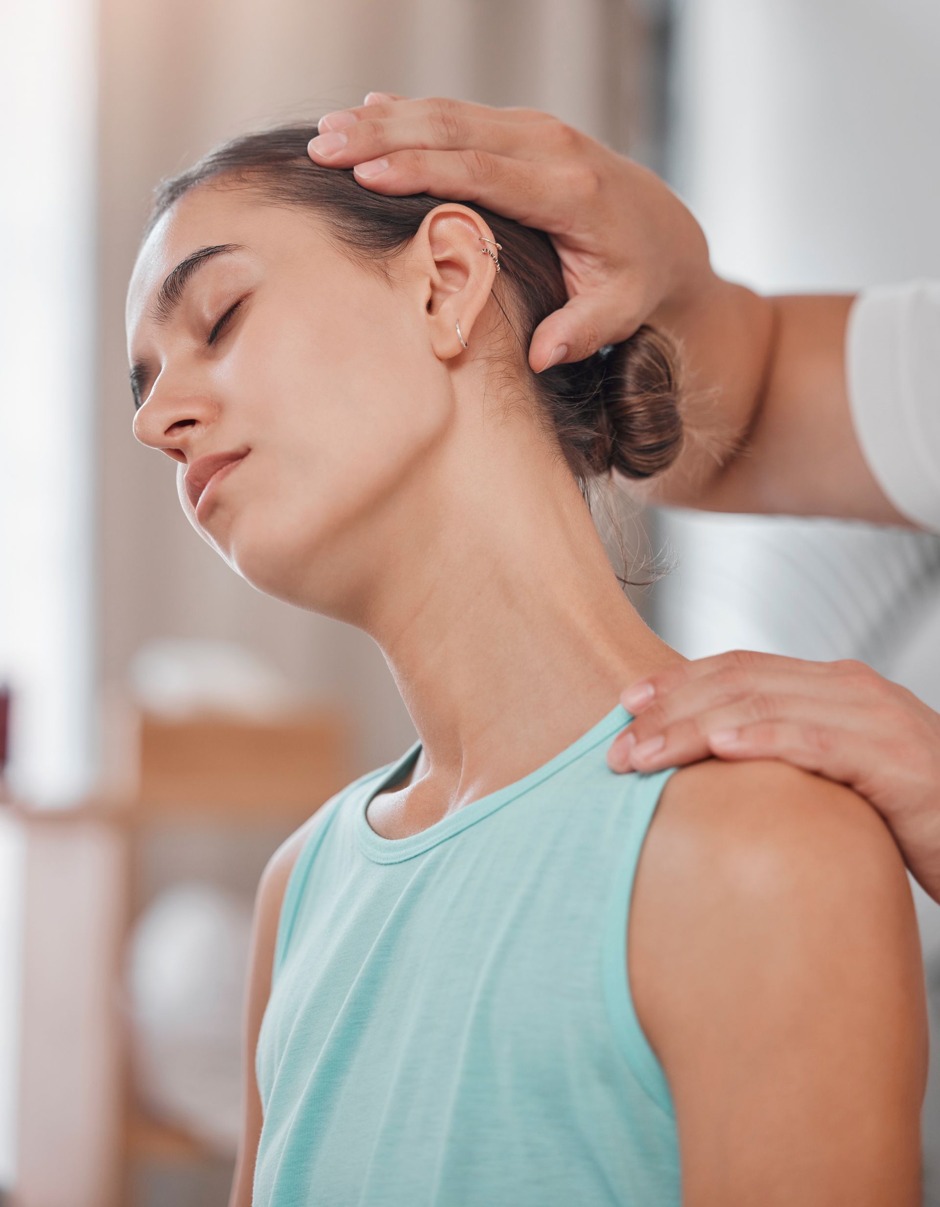 A woman is getting a neck massage from a doctor.