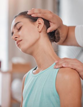 A woman is getting a neck massage from a doctor.