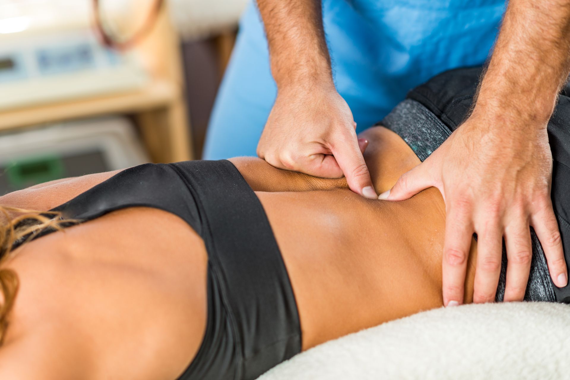 A man is giving a woman a massage on her back.