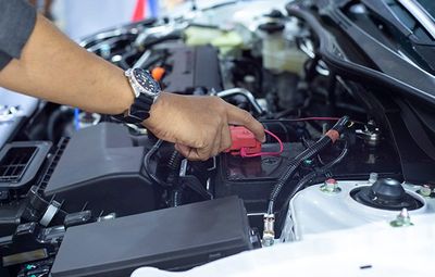 Car Inspections — Car Mechanic Working In Battery Check in Kennett Square, PA