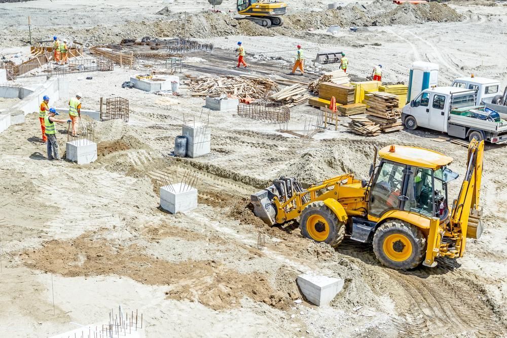 A Yellow Bulldozer Is Moving Dirt on A Construction Site — Hillery Group in Bowen, QLD