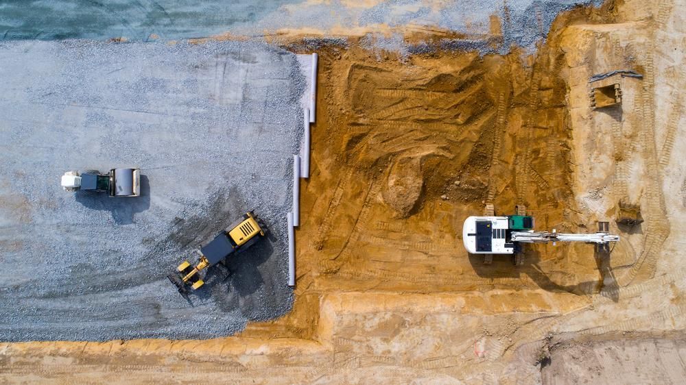 An Aerial View of A Construction Site with Trucks and Excavators — Hillery Group in Bowen, QLD