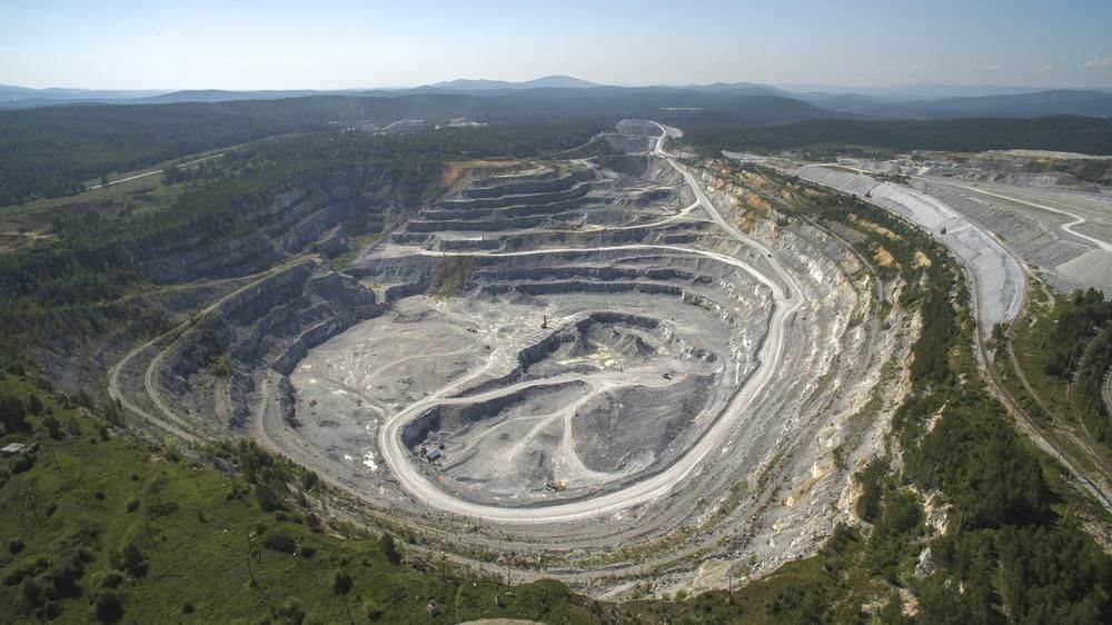 An Aerial View of A Large Quarry Surrounded by Trees and Mountains — Hillery Group in Bowen, QLD
